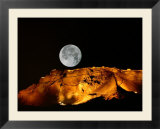 Moonrise over an illuminated ridge