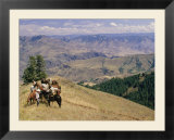 A group of horseback-riding tourists take in the view of Hells Canyon