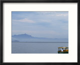 A man in a boat on a foggy morning