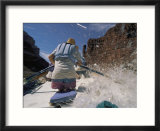 A man shoots the rapids of the Colorado River in a dory