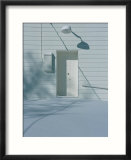 Snow blends in with the doorway of a white building