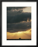 The sun shines through the clouds over the Atlantic ocean