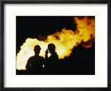 Natural gas workers silhouetted by burning dross
