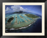 Waves break on a reefs edge near a cluster of small islands