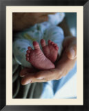 A Father Holding His Baby's Feet