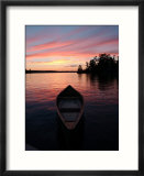Canoe Floating in Lake During Sunset