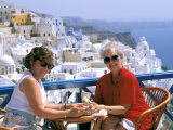 Women Having Coffee on Cafe Terrace  Santorini  Greece