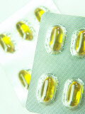 Studio Shot of Packaged Yellow Capsules in Foil Pack