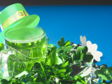 Leprechaun Hat Atop St Patrick's Day Mug of Green Beer with Shamrock Decorations
