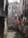 Young Adult Couple Hugging and Kissing on Bridge over Canal  Venice  Italy