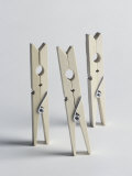 Three Wooden Laundry Pegs Standing Upright
