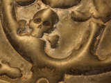 Bronze Background with Skull and Crossbones Engraved into Surface