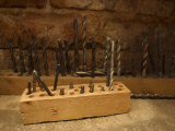 Assortment of Drill Bits in Wooden Blocks on Workbench