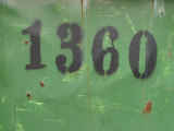 Painted Numbers on Weathered Green Painted Wall