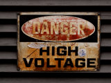 Weathered and Rusted Metal High Voltage Danger Sign