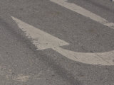 U-Turn Arrow Painted onto a Faded Blacktop Road