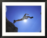 Hiker Leaping Over Rocks