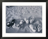 Four Pairs of Shoes on the Sand