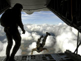 Pararescuemen Jump Out the Back of a C-130 Hercules