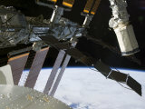 End Effector of Endeavour's Robot Arm Appears Amidst Parts of the International Space Station