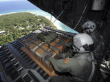 Airmen Push Out a Pallet of Donated Goods over the Island of Yap from C-130 Hercules  Dec 19  2008