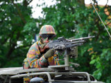 Belgian Army Soldier Handling a Machine Gun Atop a Unimog Vehicle