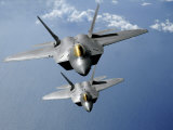 Two F-22 Raptors Fly over the Pacific Ocean