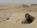 Mamba Armored Vehicle Sits in Front of a Iraqi Magazine That Has Been Hit by a Coalition Bomb