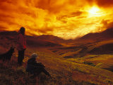 Women with Dog Watch Dramatic Sunset over Tombstone National Park