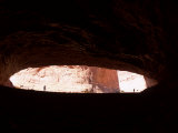 Silhouette Photo of Two People Taken from Inside a Cavern