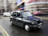 London Cab Traveling Through Traffic on a Rainy Day  England  London