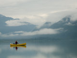 Woman and Her Dog Paddle across a Still Chilkoot Lake in Alaska  Chilkoot Lake  Alaska