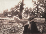 Woman Sitting in the Wood Concentrating on Winding the Wool around a Spindle