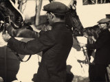 Jockeys Bridling their Horses