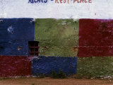 Wall Painted in Checkered Colors  Interrupted by a Small Window with an Iron Grate