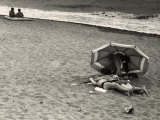 Young Couple  in an Amorous Embrace  Lying on the Beach on the Seashore