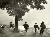 Little Girl with Group of Fishermen Gathered around a Tree