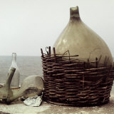 Demijohn and Glass Flasks Left on the Seashore