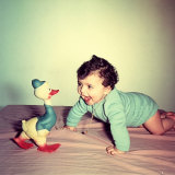 Baby Crawling Next to a Toy Duck