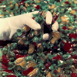 Gloved Hand Holding a Handful of Candies