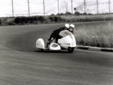 Two Motorcyclists in a Race  on a Two Seater Motorcycle