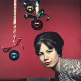Young Woman with Christmas Ornaments on Which Merry Christmas is Written