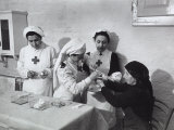 Nurse Attending to an Elderly Woman in a Hosptial During World War II