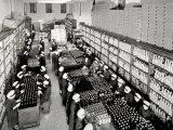Distillery Warehouse where Numerous Women Workers around Tables   Packing the Bottles for Shipping