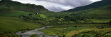 Stream Through Lush Mountain Landscape  Distant Cottages  Ireland