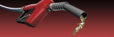 Gasoline Being Splashed from a Gas Nozzle on a Red Background