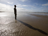 Another Place Sculpture by Antony Gormley on the Beach at Crosby  Liverpool  England  UK