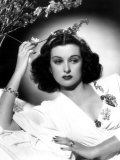 She Knew All the Answers  Joan Bennett  Reclining and Touching a Flower  1941