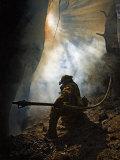 A firefighter blasts water in attempts to drown stubborn flames