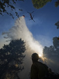 A helicopter makes water drops on a wildfire in Boise National Forest